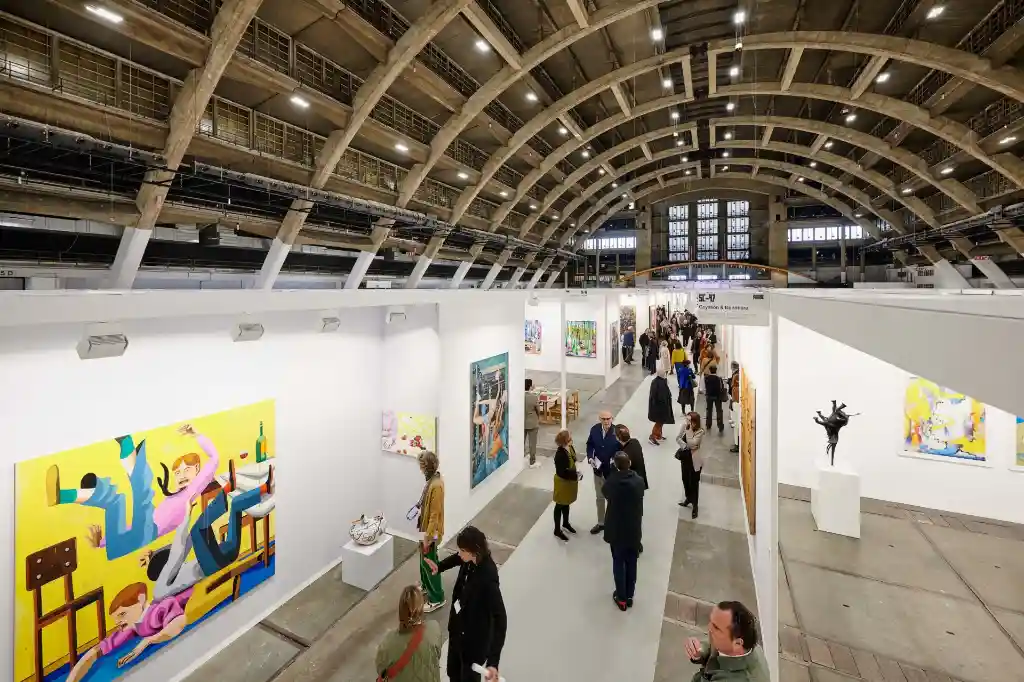 Art Brussels exhibition hall showing exhibitor and visitor interaction