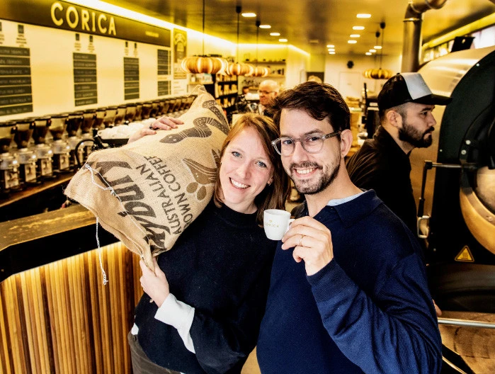 Smiling B2B clients holding coffee products representing automated webshop